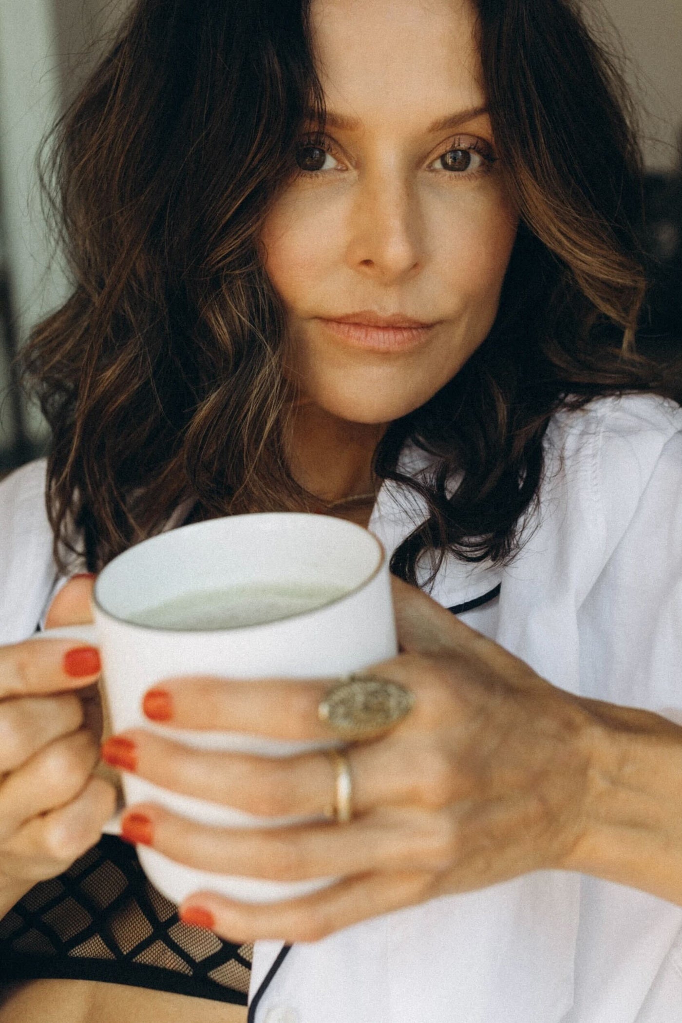 Woman holding a white mug with a blurred background